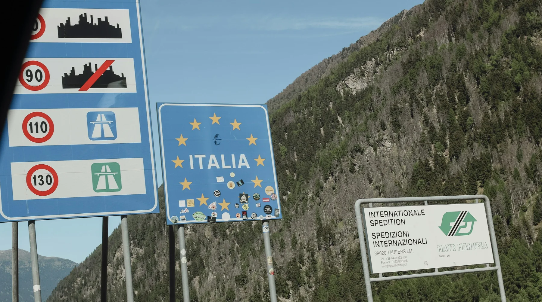 Italy and EU border sign on a mountain road