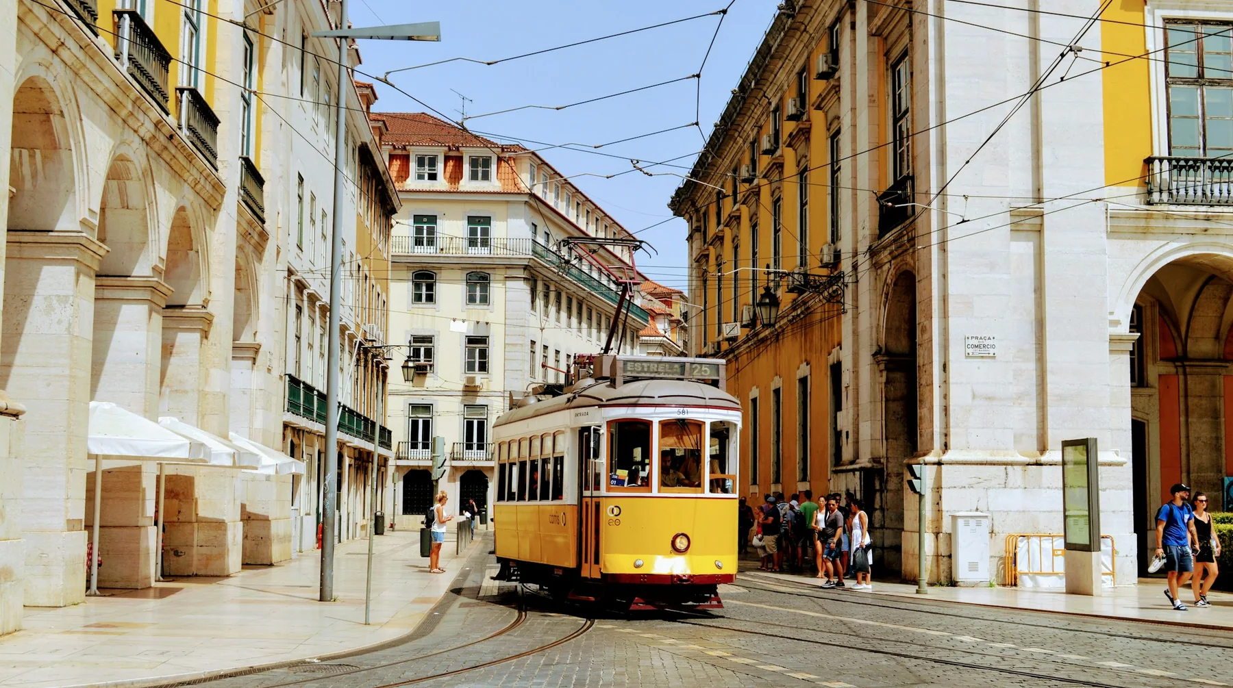 A yellow tram on a Lisbon street
