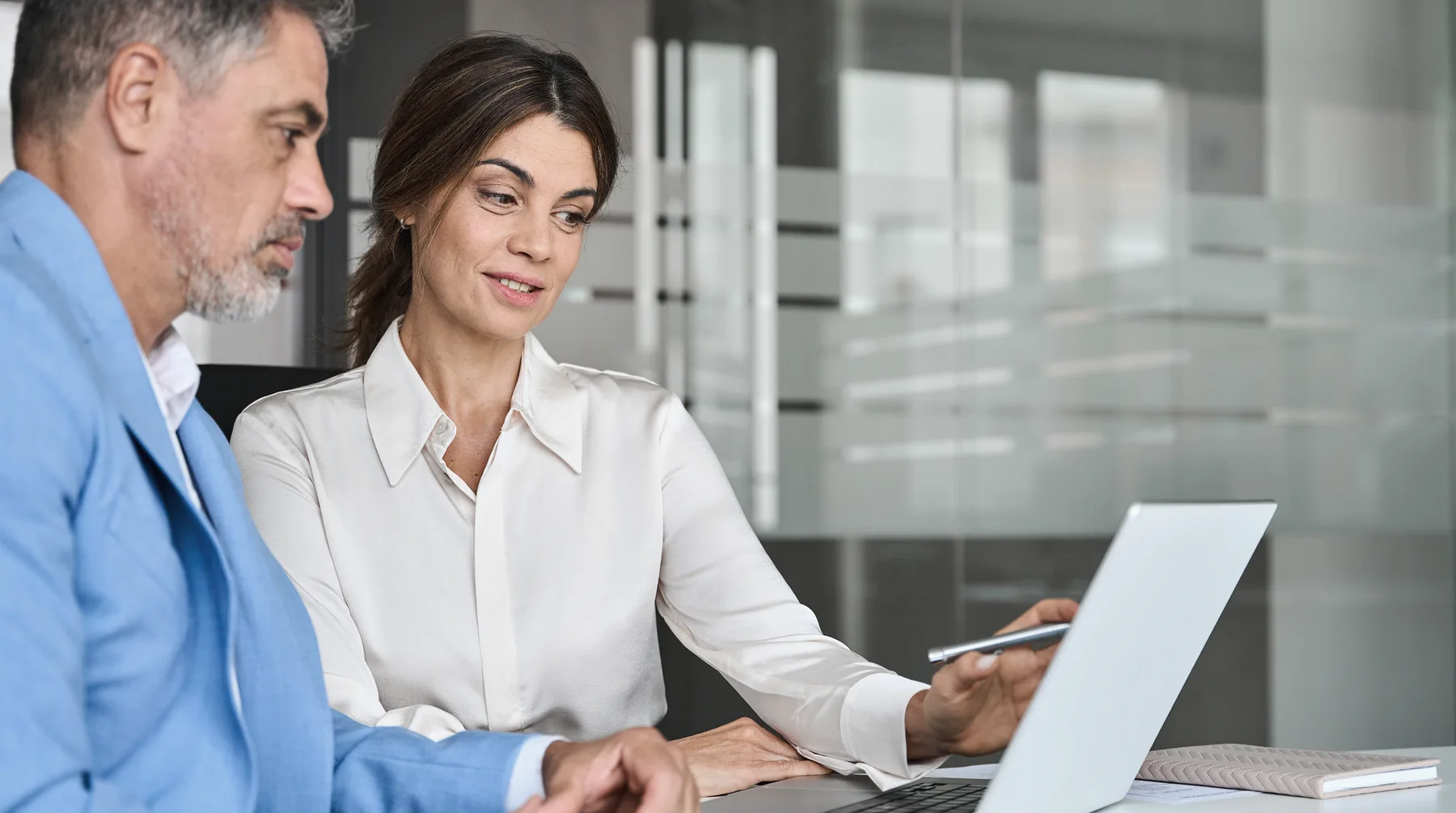 A client discusses opening an account with a bank specialist in a bright office