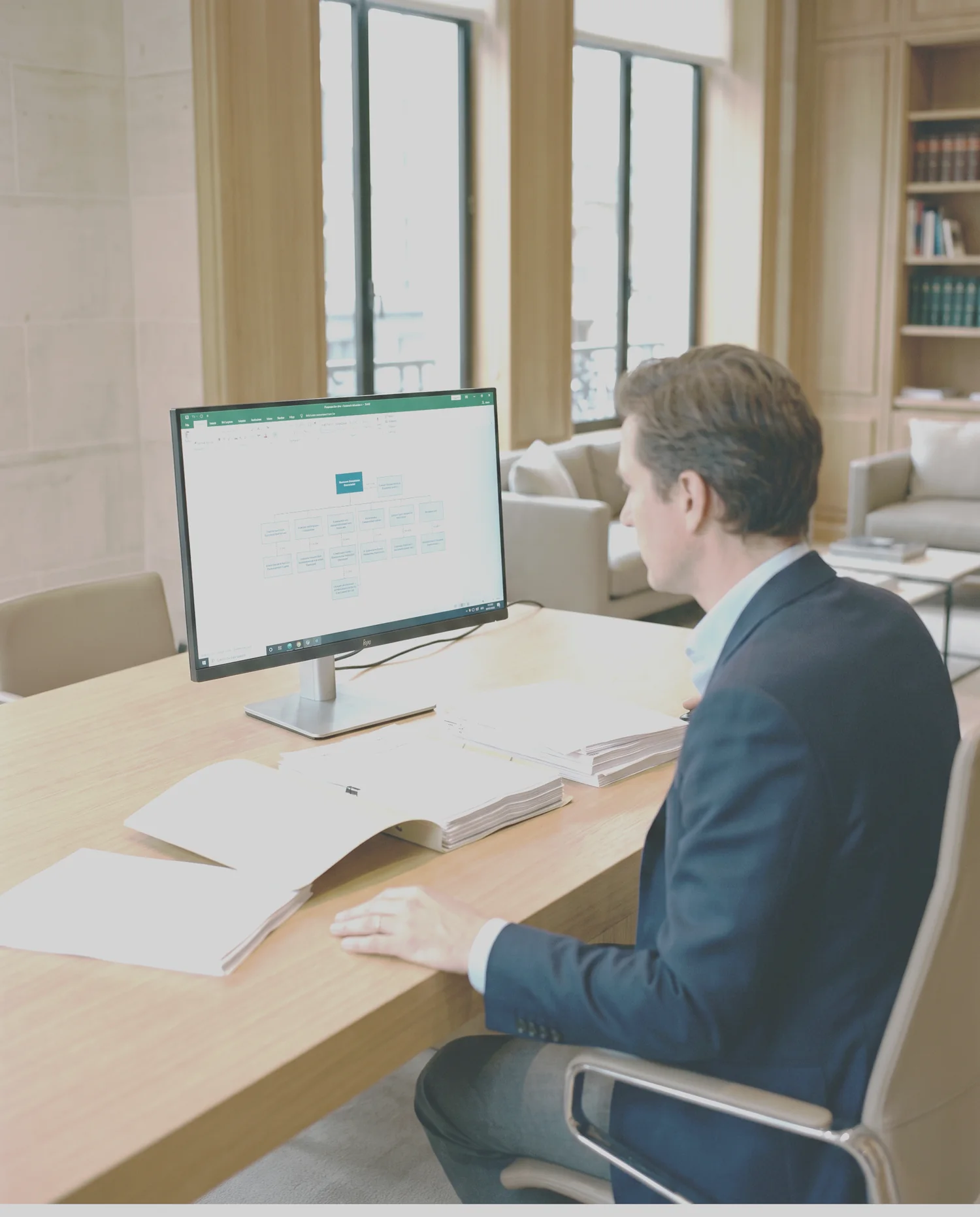 An analyst studying a corporate structure and documents in a private practice office
