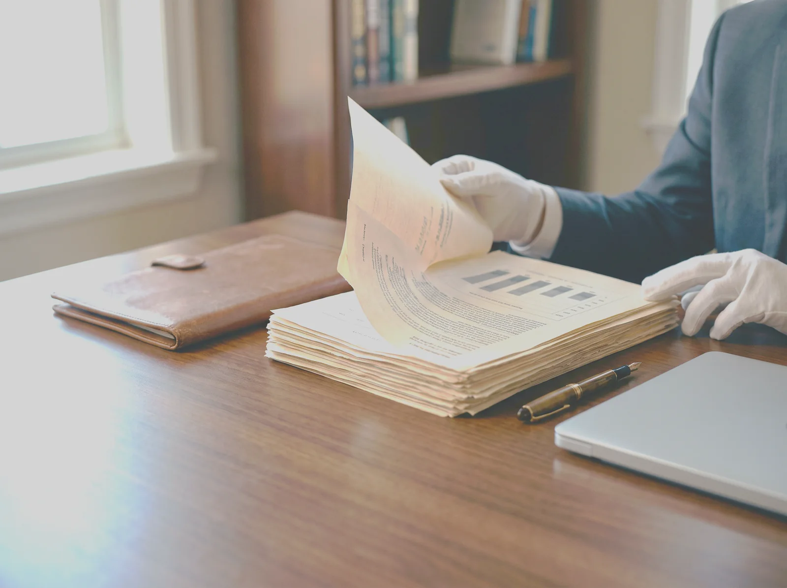 Banking and corporate documents with an ownership chart on a solid wood desk