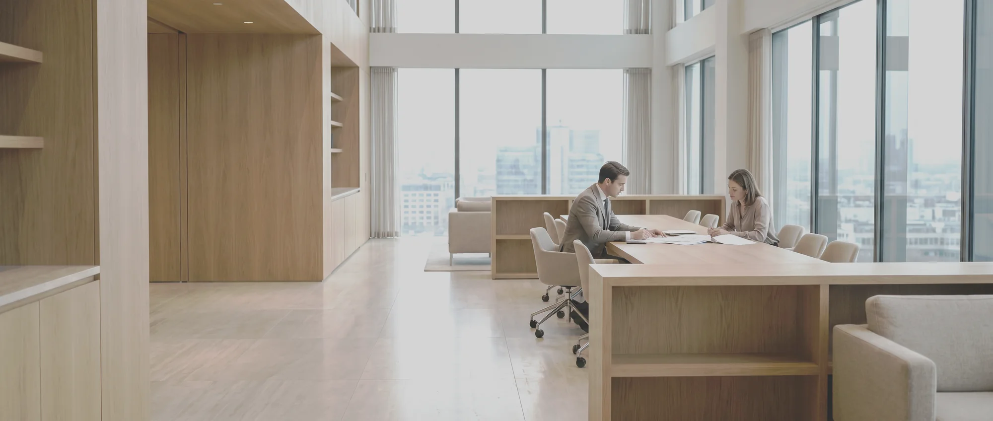An analyst and a senior adviser working with documents in a private practice office