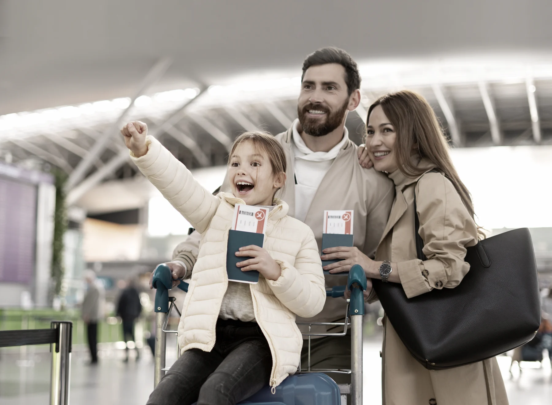 A happy family with passports and tickets at the airport before departure