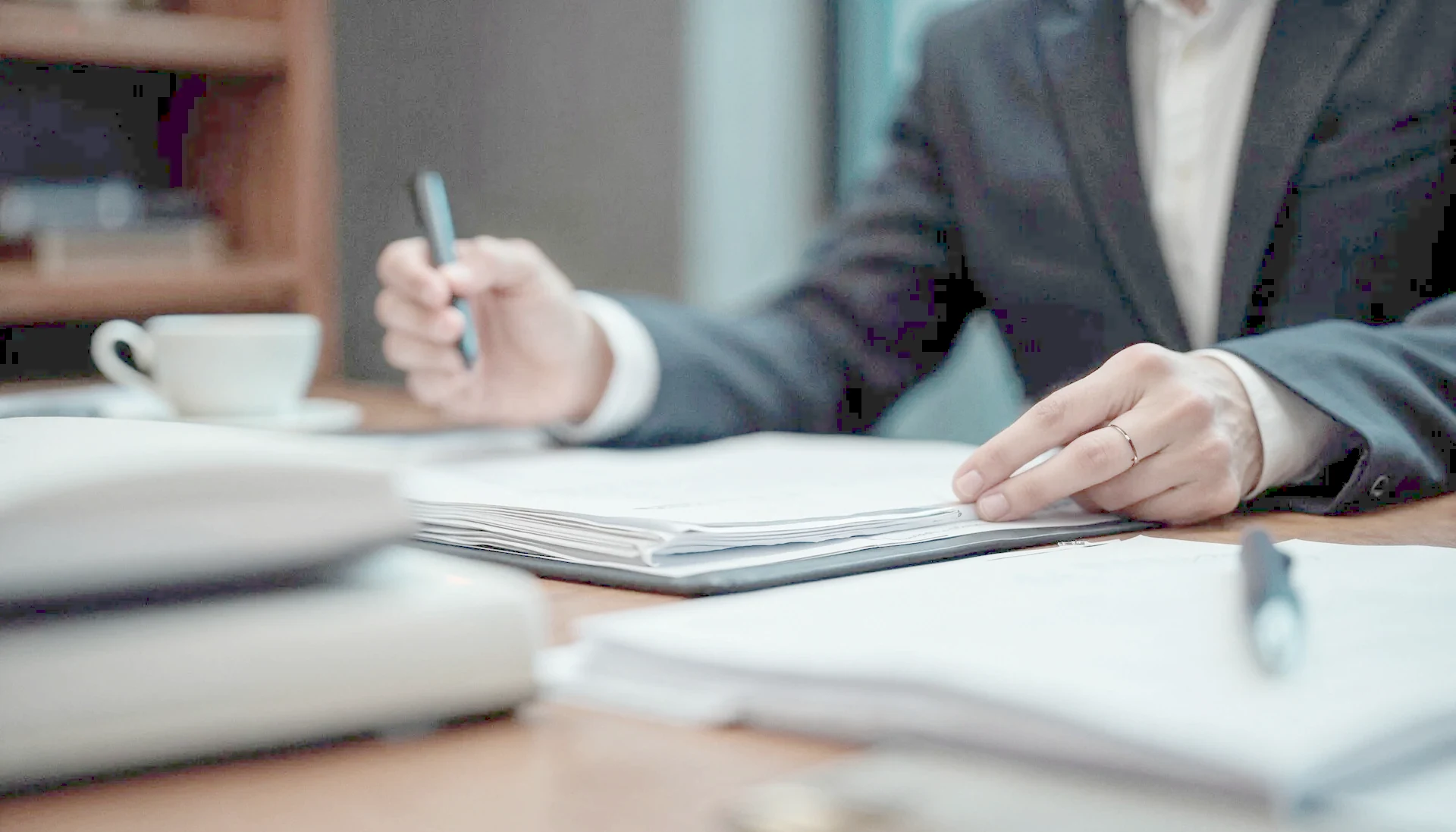 A lawyer checking a company’s corporate documents at a desk