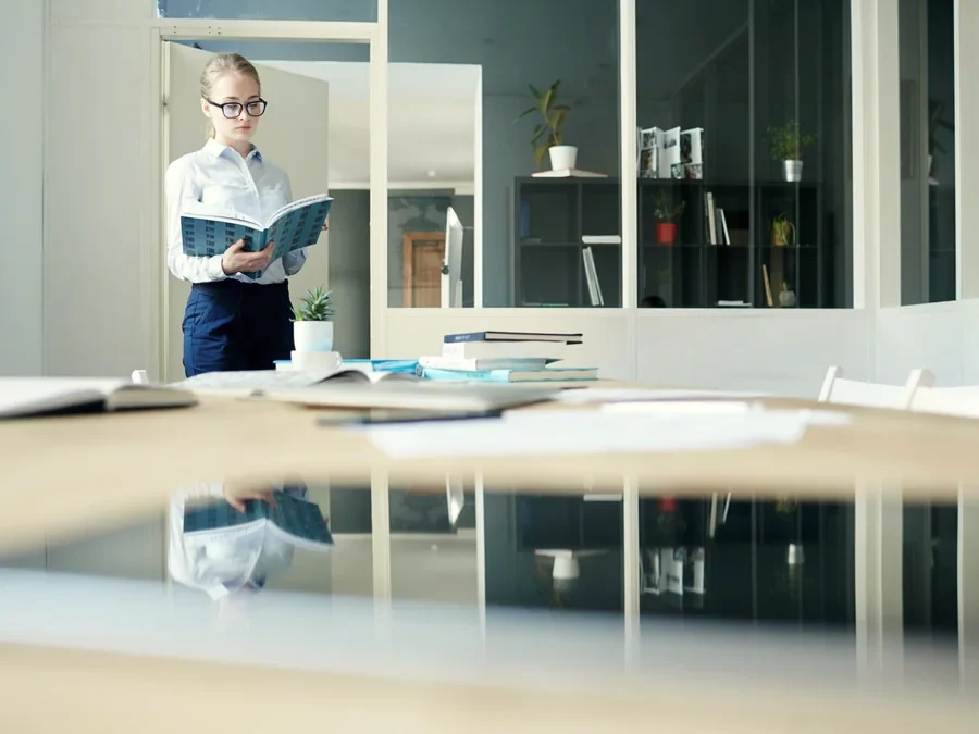 A specialist checking company documents in a meeting room