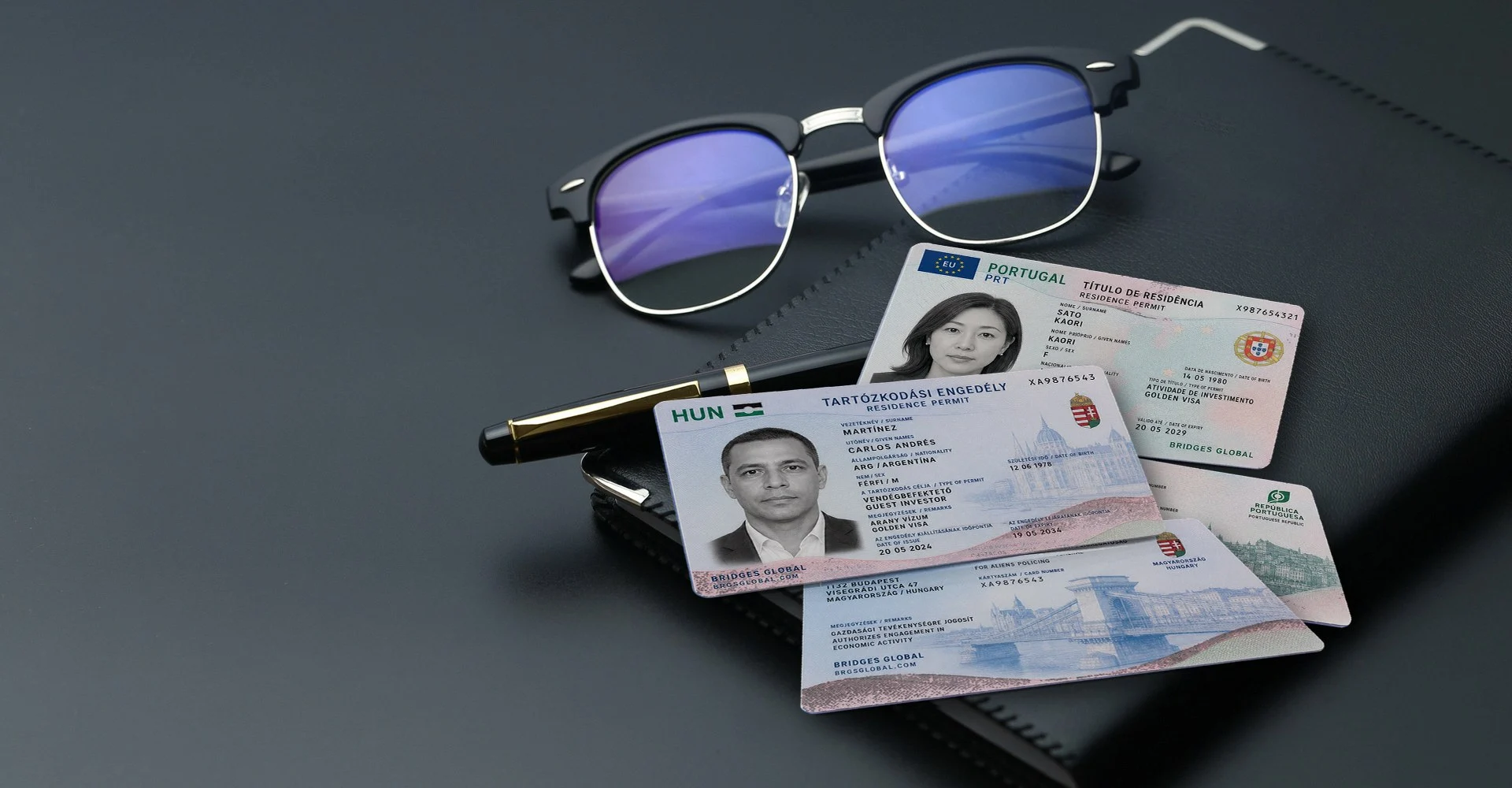Hungarian and Portuguese residence cards marked BRIDGES GLOBAL with a fountain pen and glasses on a desk